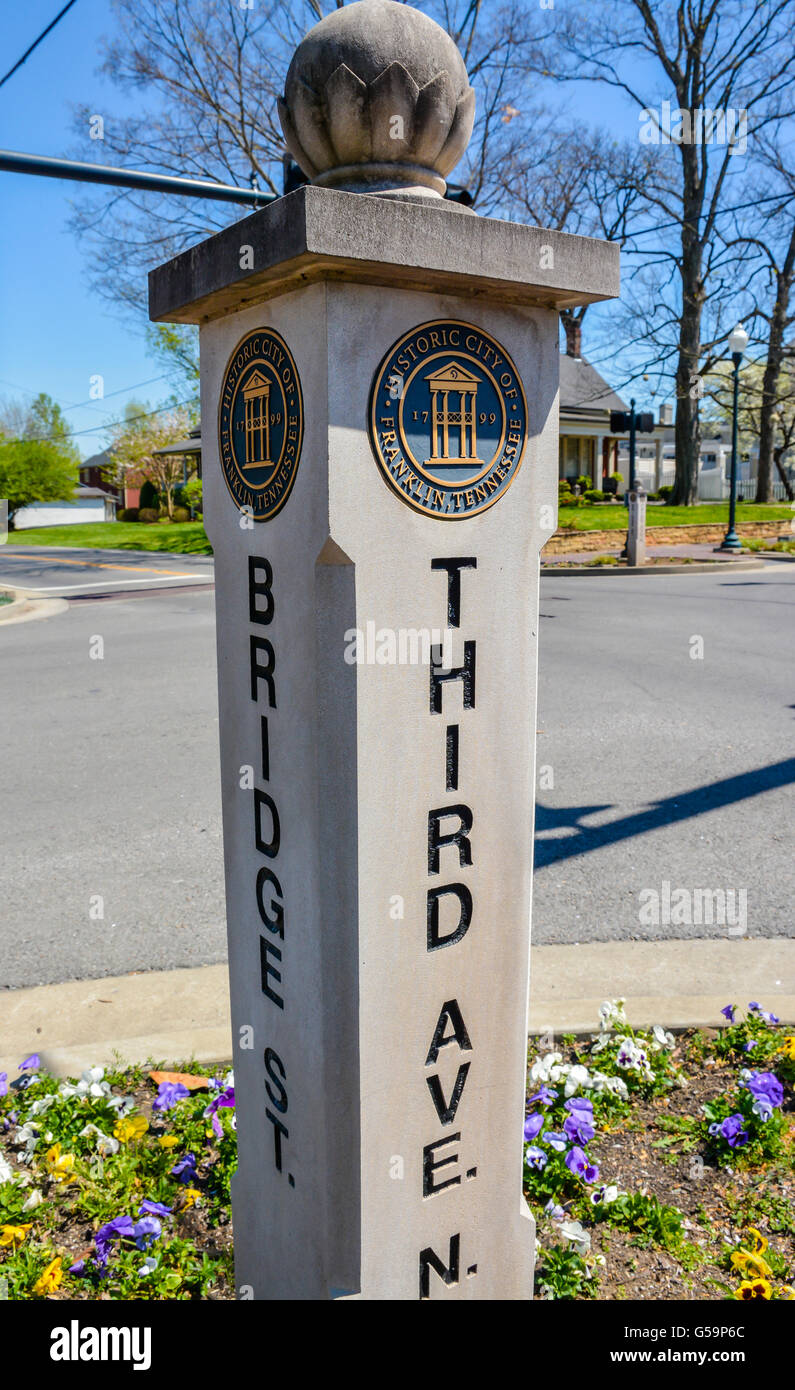 A concrete pillar Street Sign with emblem designates Bridge Street and Third Avenue crossing in Historic Franklin, TN Stock Photo
