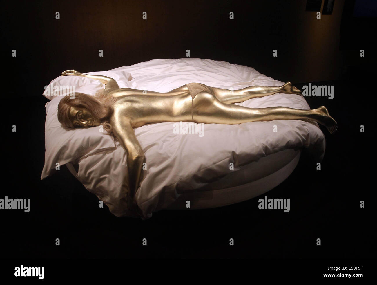 A model of Shirley Eaton as famous Bond girl Jill Masterson painted gold from the film Goldfinger (1964) at the Fifty Years of Bond Style press view at the Barbican, London. Stock Photo