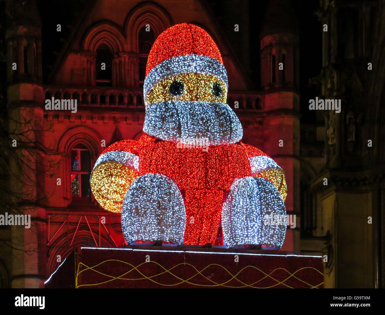 Christmas illuminated Big Santa Claus sitting on town hall in Manchester, England, United Kingdom Stock Photo