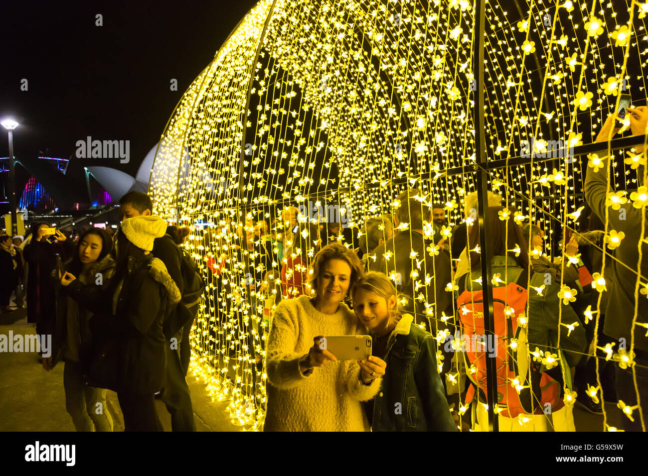 Locals and tourists take selfies of each other next to the cathedral of light at Vivid Sydney 2016. Stock Photo