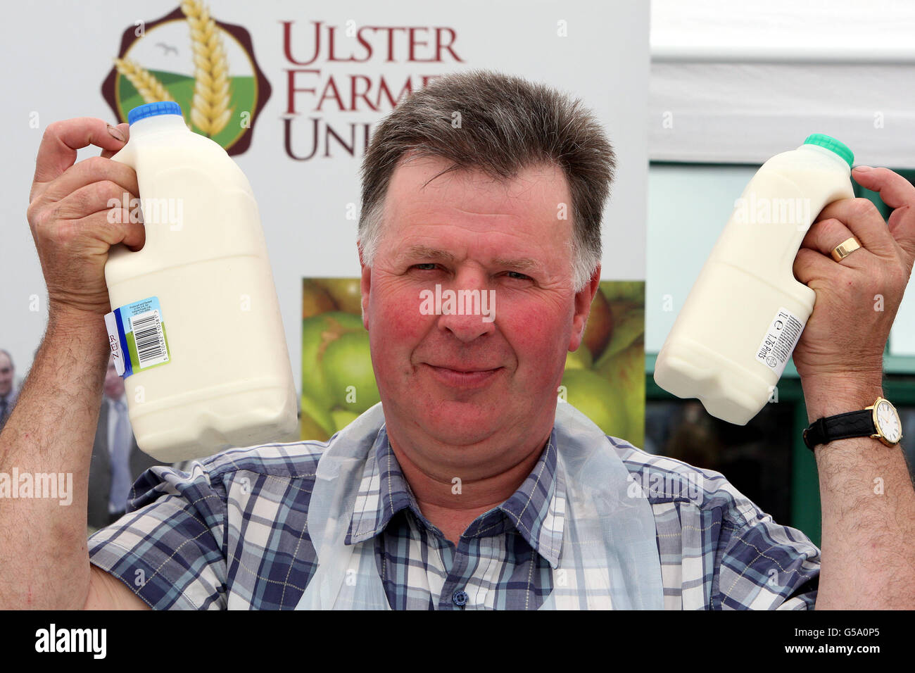 Dairy farmer Andrew Addison holds two bottles of milk which were sold  directly to the public today at UFU HQ in Antrim Road, Belfast, for the  price farmers are paid for their
