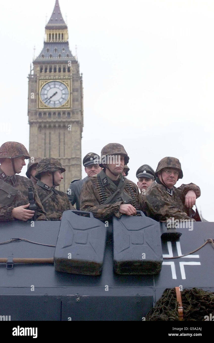 Members of the WW2 re-enactment club 'Second Battle Group' dressed in Waffen-SS uniform ride in a German Sdkfz 251 half-track in Parliament Square, London. For only the 2nd time ever, the street was closed to traffic to allow filming for a major new BBC documentary series. * Invasion, which examines Britain's history of defence will be presented by Dan Cruikshank on BBC2. Stock Photo
