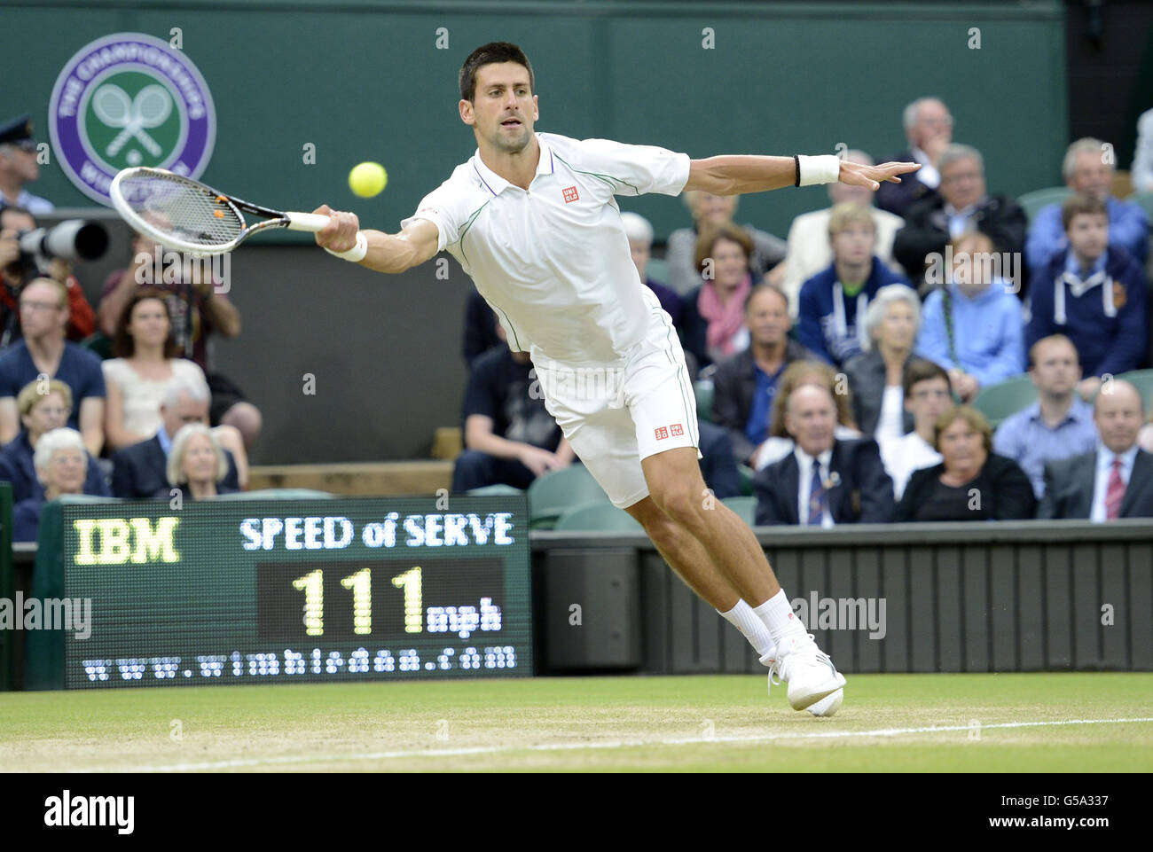 Serbia's Novak Djokovic in action against Switzerland's Roger Federer in the Royal Box during day eleven of the 2012 Wimbledon Championships at the All England Lawn Tennis Club, Wimbledon. Stock Photo