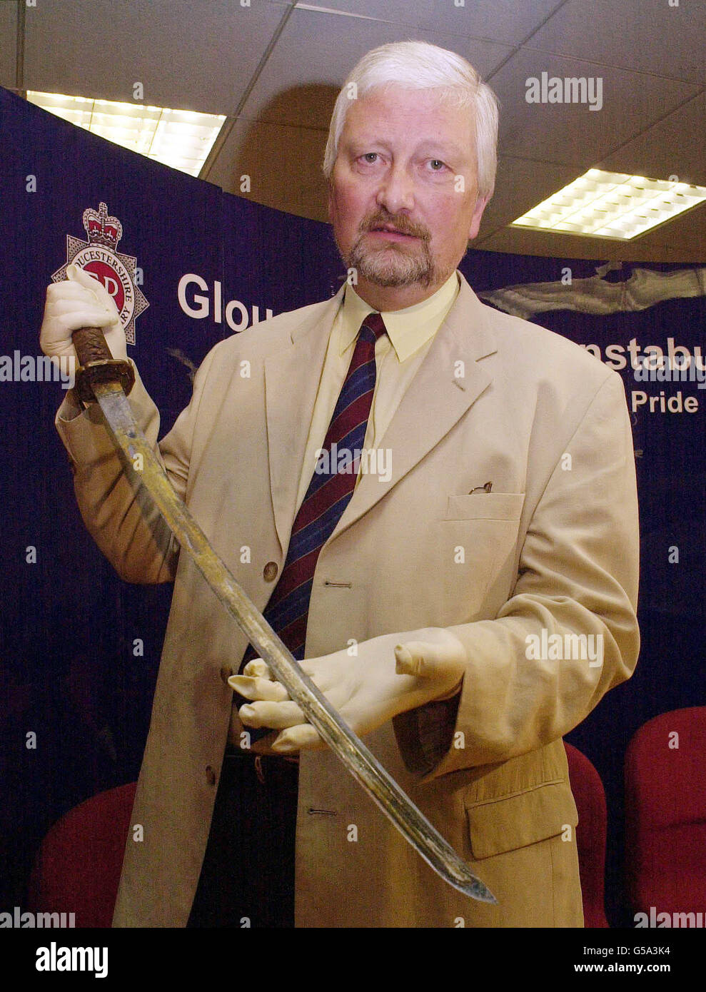 Cheltenham Lib Dem MP Nigel Jones, who was nearly killed in a Samurai sword attack, holds the weapon which nearly claimed his life and killed his best friend. *...His attacker, Robert Ashman, 50, of Lansdown Place, Cheltenham, was proved to be behind the frenzied attack in which Mr Jones was injured and his aide Andrew Pennington killed. The assault took place during a surgery at the Lib Dem offices in Cheltenham in January last year. Gloucestershire County Cllr Mr Pennington, 39, was left with nine deep stab wounds, six of which passed all the way through his body. Jones escaped with severe Stock Photo