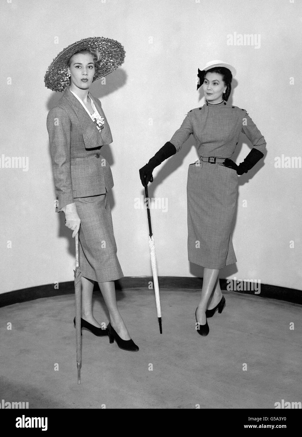 The touch of French fashion designer Christian Dior is on evidence in these models at his show at the Savoy Hotel, London. Left is 'The Wimbledon', right is 'The Trompette'. Stock Photo