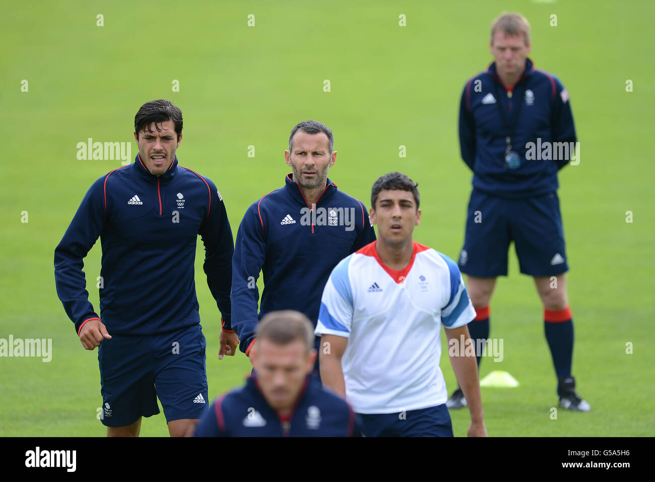 Great Britain coach Stuart Pearce (right) watches over the Welsh contingent of James Tomkins (left), Ryan Giggs, Neil Taylor and Craig Bellamy (bottom) during a training session at Champneys Hotel and Spa, Leicestershire. Stock Photo