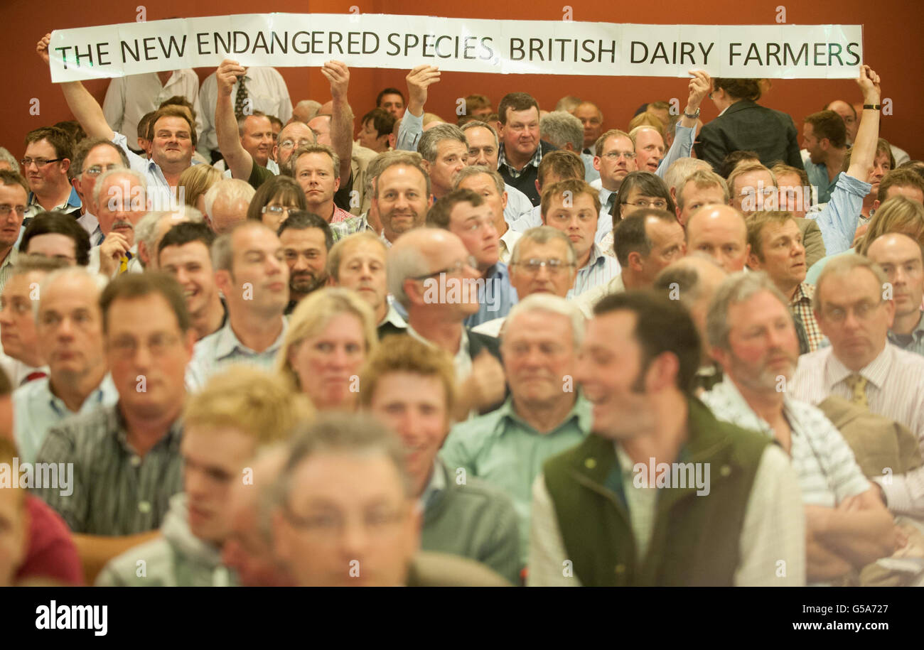 British dairy farmers hold a banner at the National Farmer's Union 'Dairy Summit' in Westminster, central London. Stock Photo