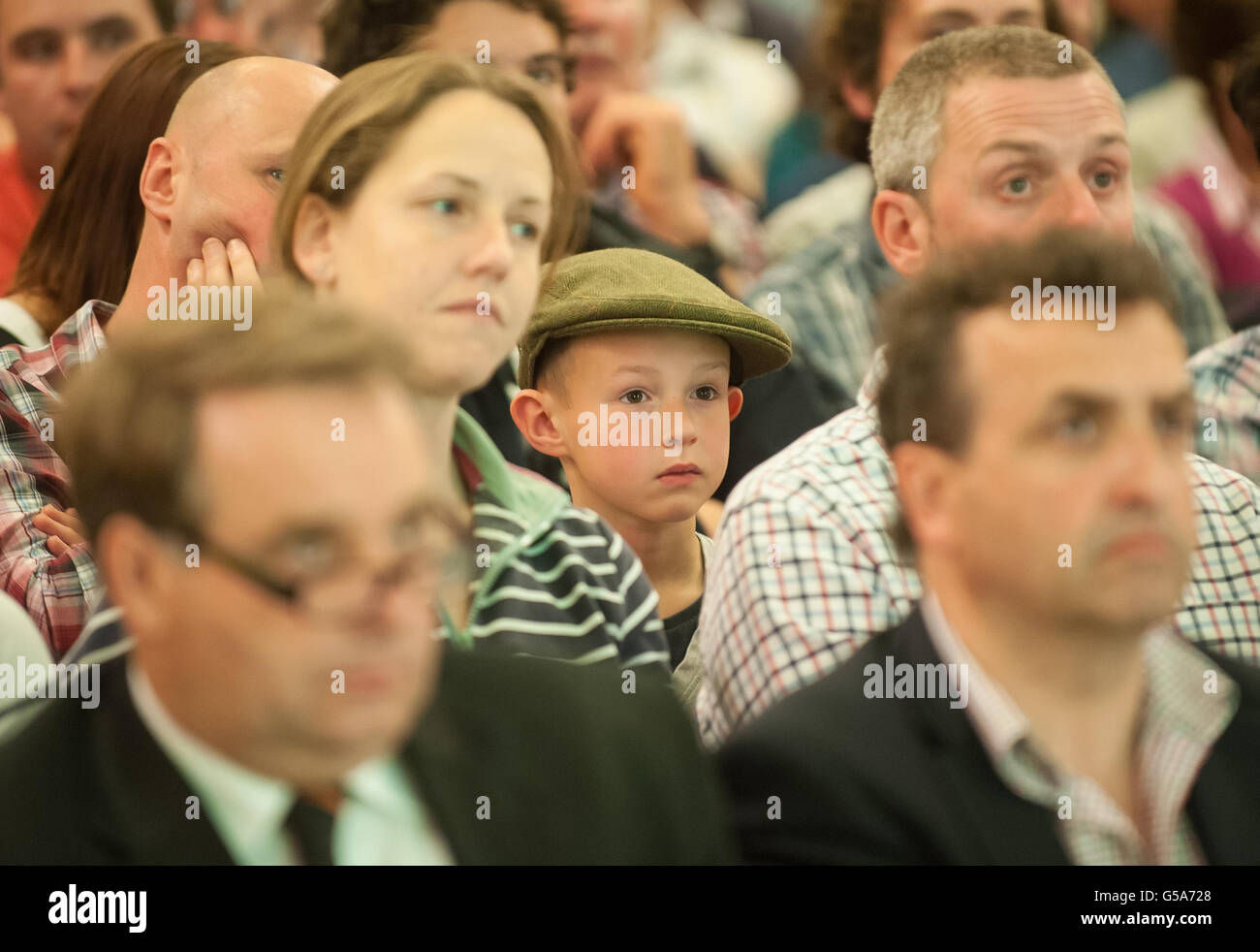 Matthew Morley (centre), from Derbyshire, sits among delegates at the National Farmer's Union 'Dairy Summit' in Westminster, central London. Stock Photo