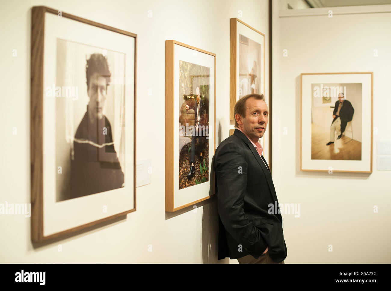 Photographer David Dawson poses with works from 'An Artist's Life: Photographs of Lucian Freud by Cecil Beaton and David Dawson', which is on display at Sotheby's, in London, from 10 July to 11 August 2012. Stock Photo