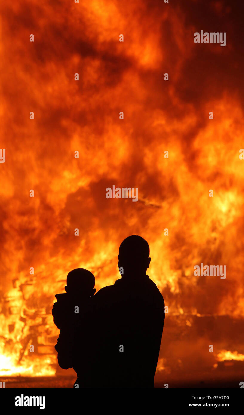 People gather at a huge bonfire on the Shankill Road in Belfast as