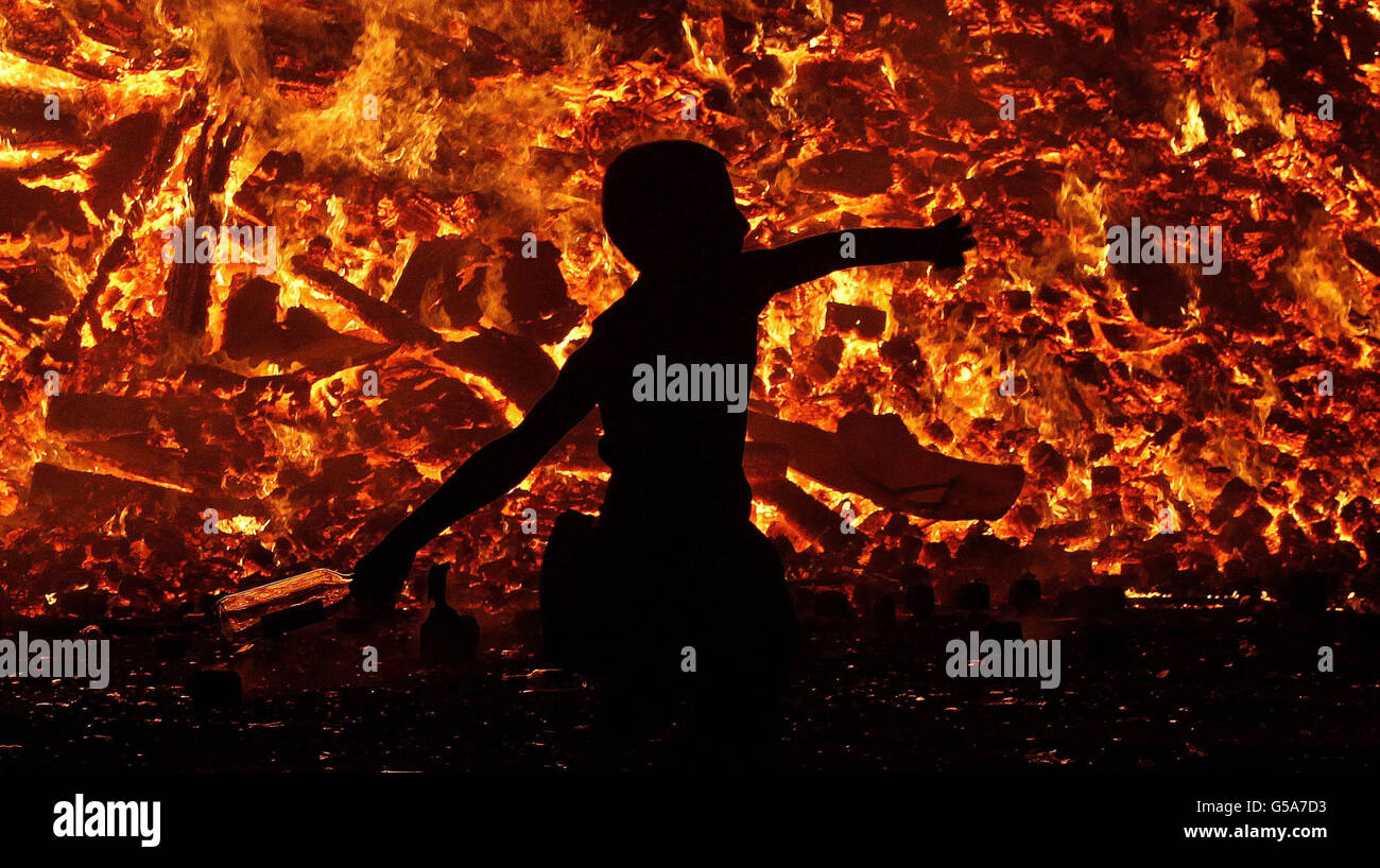 People gather at a huge bonfire on the Shankill Road in Belfast as