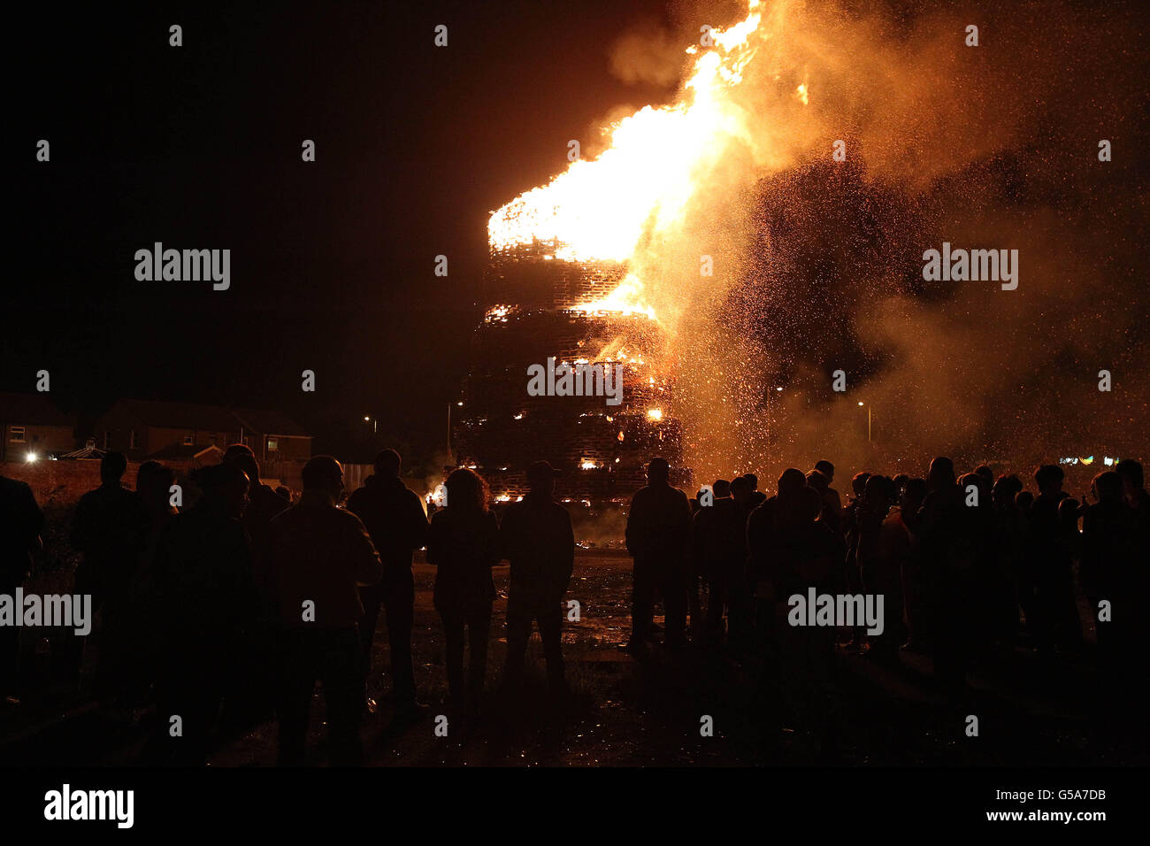 People gather at a huge bonfire on the Shankill Road in Belfast as
