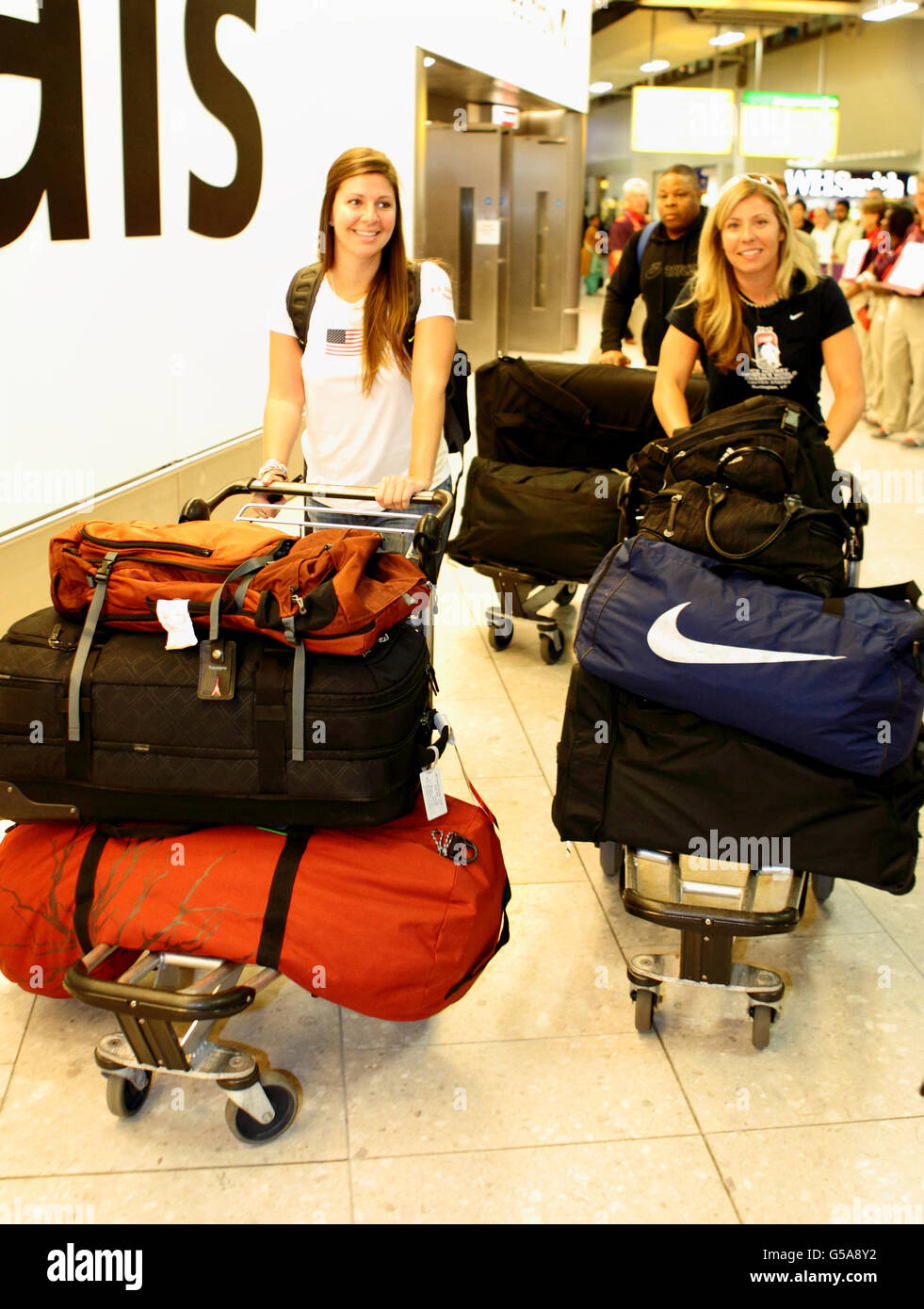 Members of the USA Olympic Team are met by LOCOG members as they arrive at Heathrow Airport. Stock Photo