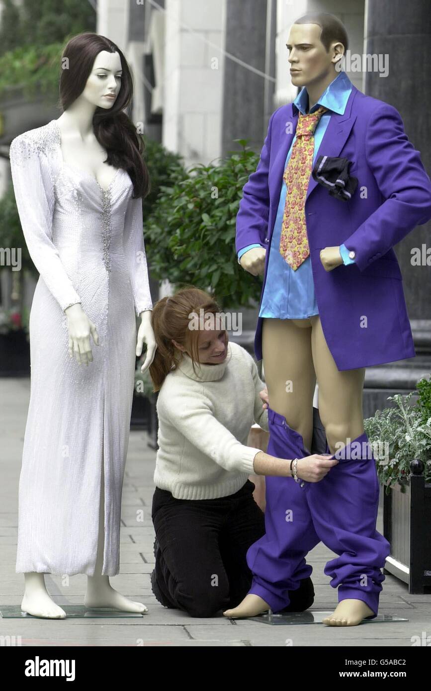 Rachel Finch-Knightley puts the finnishing touches to the suit donated by Jonathan Ross, as a dummy of Elizabeth Taylor looks on, before the Heat magazine celebrity clothes auction at the Park Lane Hotel, in London. * The auction of celebrity clothes will raise money for the Crusaid charity the biggest HIV and AIDS fundraiser in the UK. Stock Photo