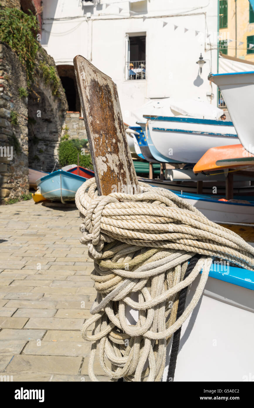 Ropes on the boat, Riomaggiore village on cliff rocks and sea, Seascape in Five lands, Cinque Terre National Park, Liguria Italy Stock Photo