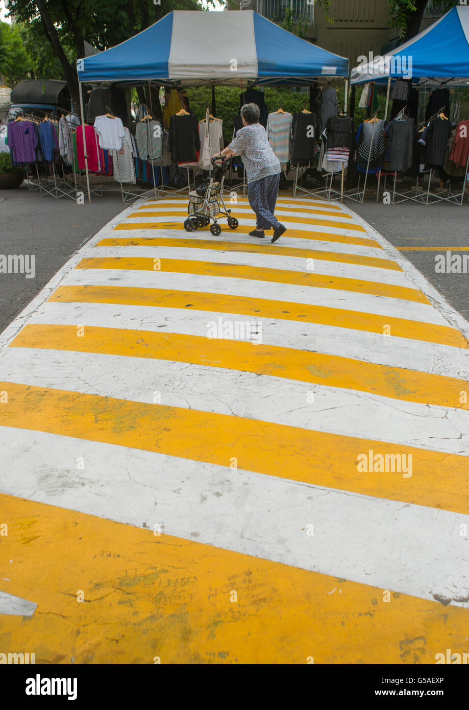 South Korea, National Capital Area, Seoul, old woman crossing the road in yangcheong Stock Photo