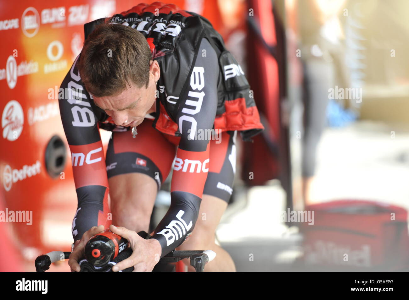 BMC's Cadel Evans warms outside his team bus up before his time trial during the Prologue Stage of the 2012 Tour de France in Liege, Belgium. Stock Photo