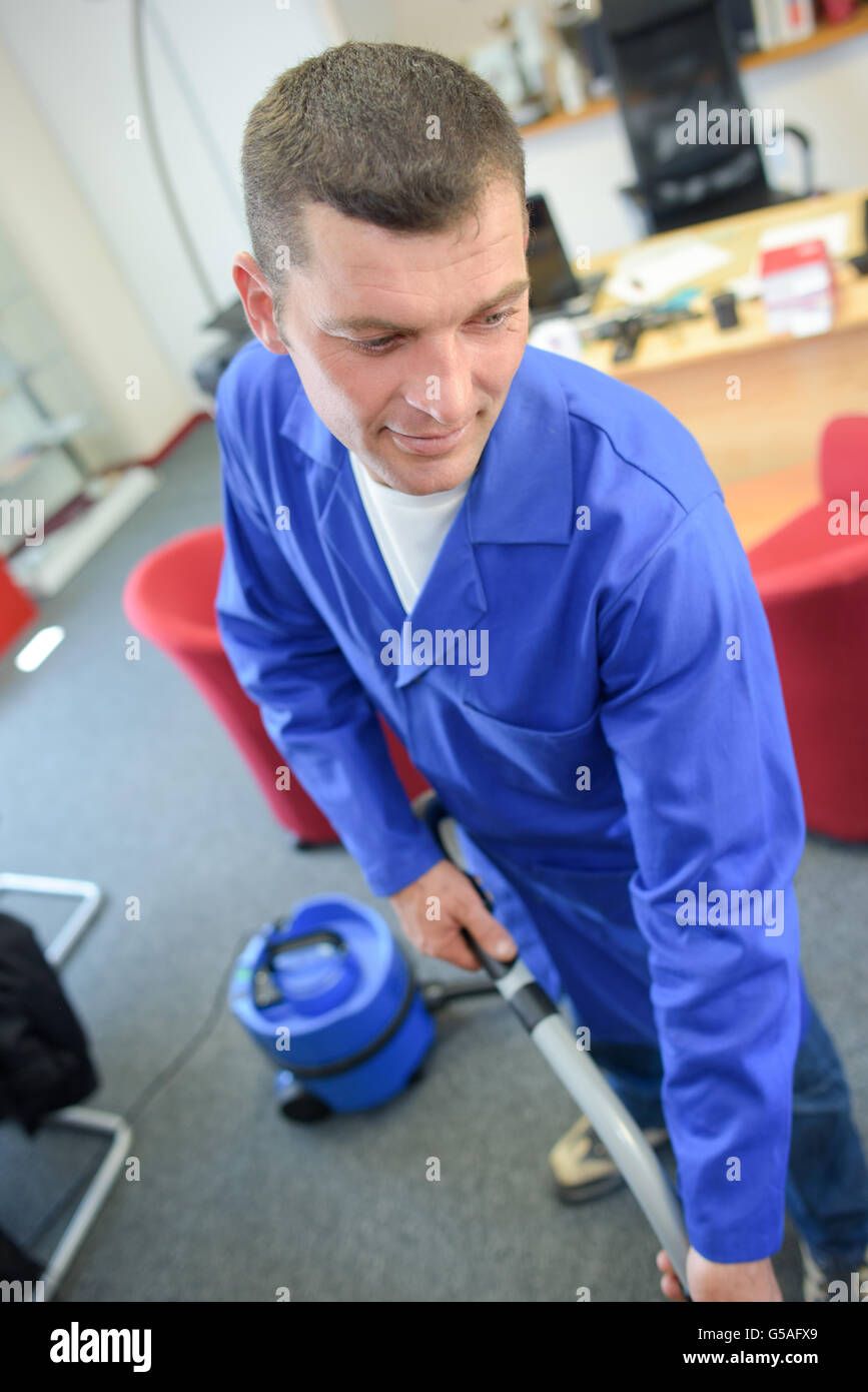 Professional cleaner vacuuming office Stock Photo Alamy