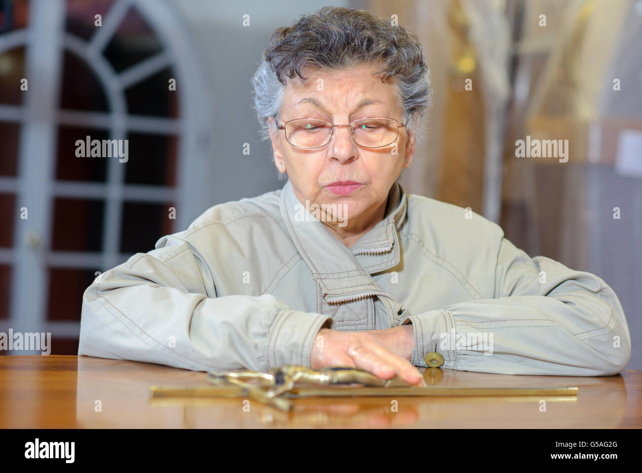 Lady touching lid of coffin Stock Photo