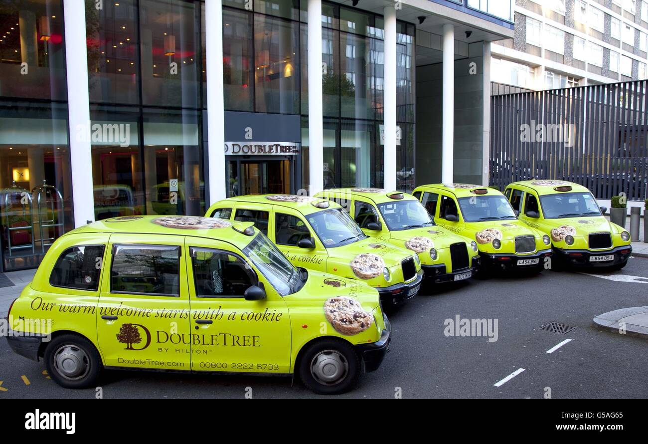 Some of the exclusive fleet of 30 branded taxis are parked up outside a Hilton DoubleTree hotel in London, to celebrate the opening of DoubleTree by Hilton London Heathrow Airport. Stock Photo
