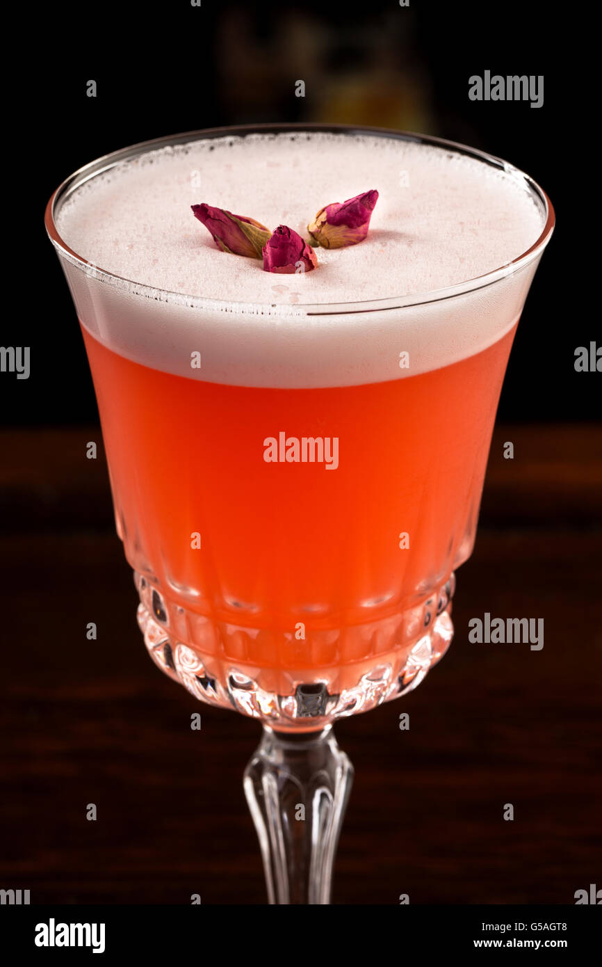 Sour cocktail with egg white with mini roses Stock Photo Alamy