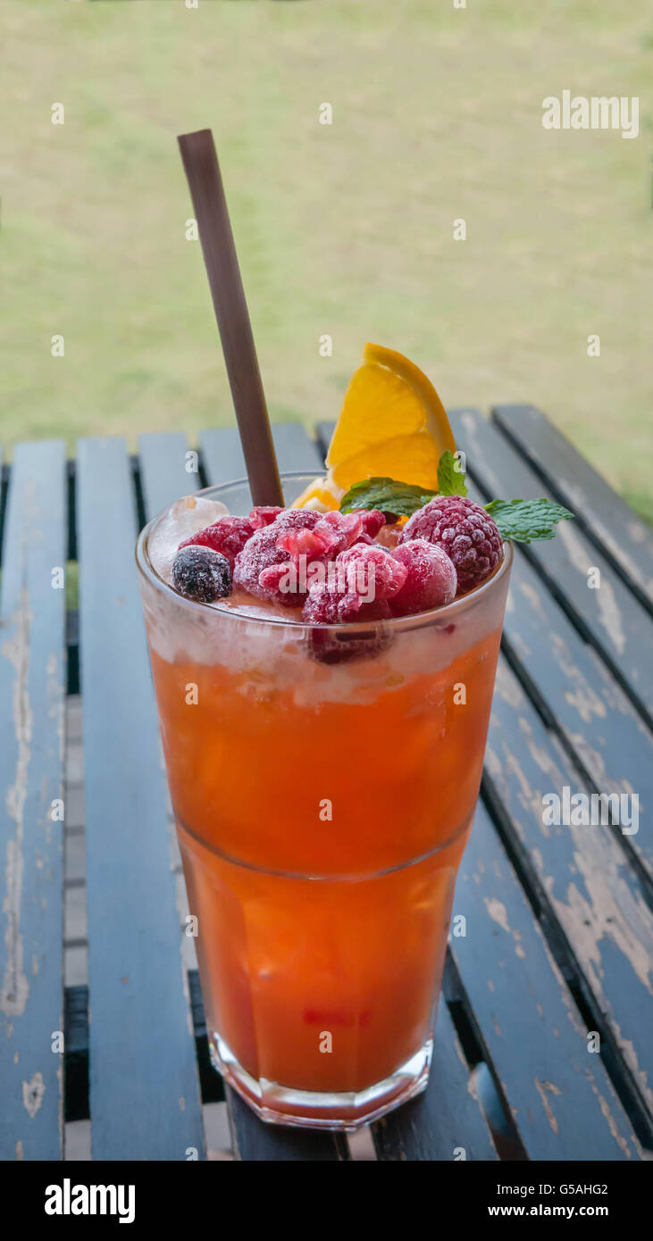 Ice refreshing summer drink with lots of different fruits Stock Photo