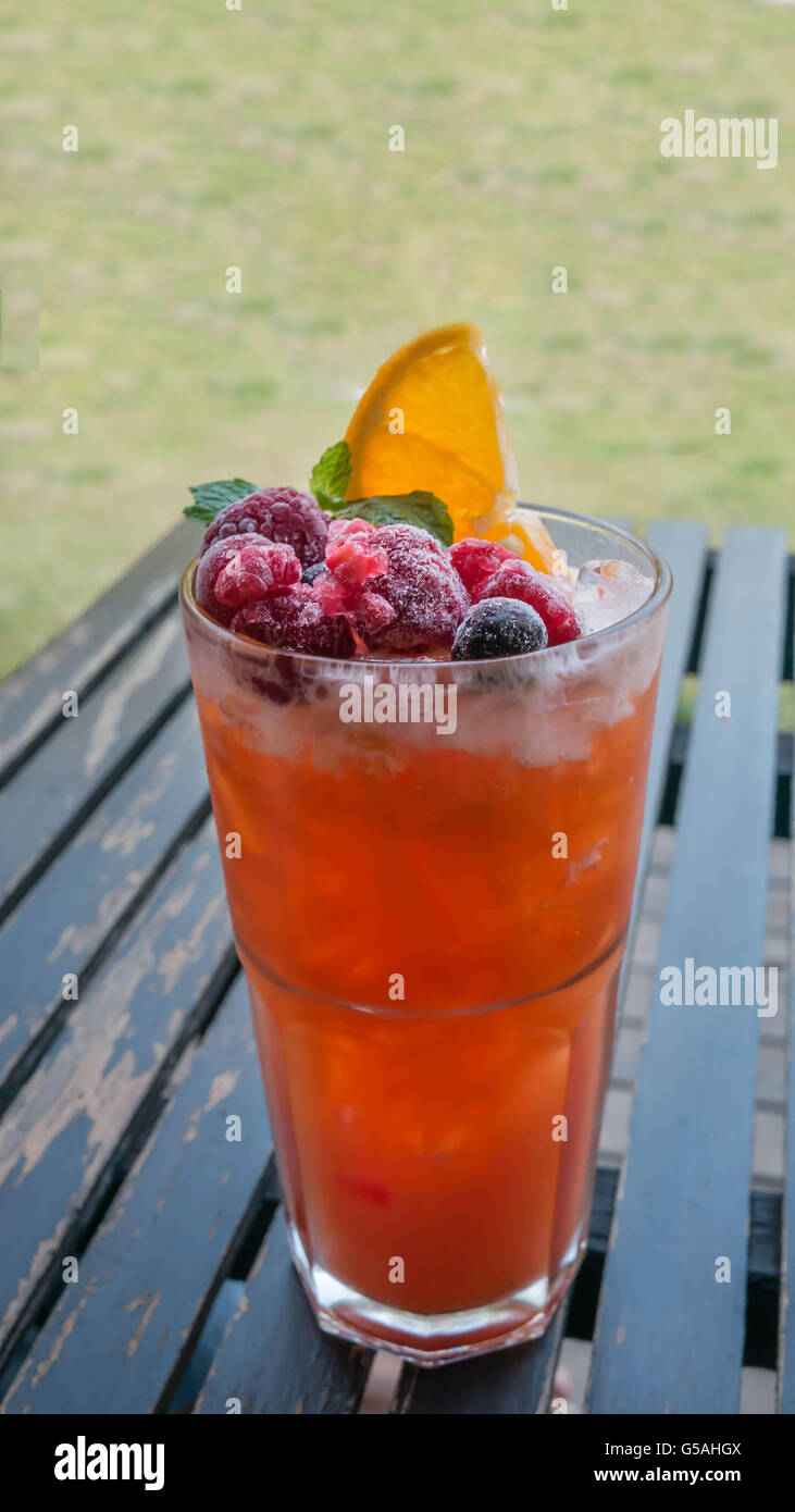 Ice refreshing summer drink with lots of different fruits Stock Photo