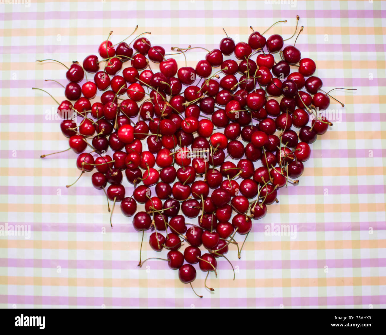 cherries in a heart-shaped bowl Stock Photo