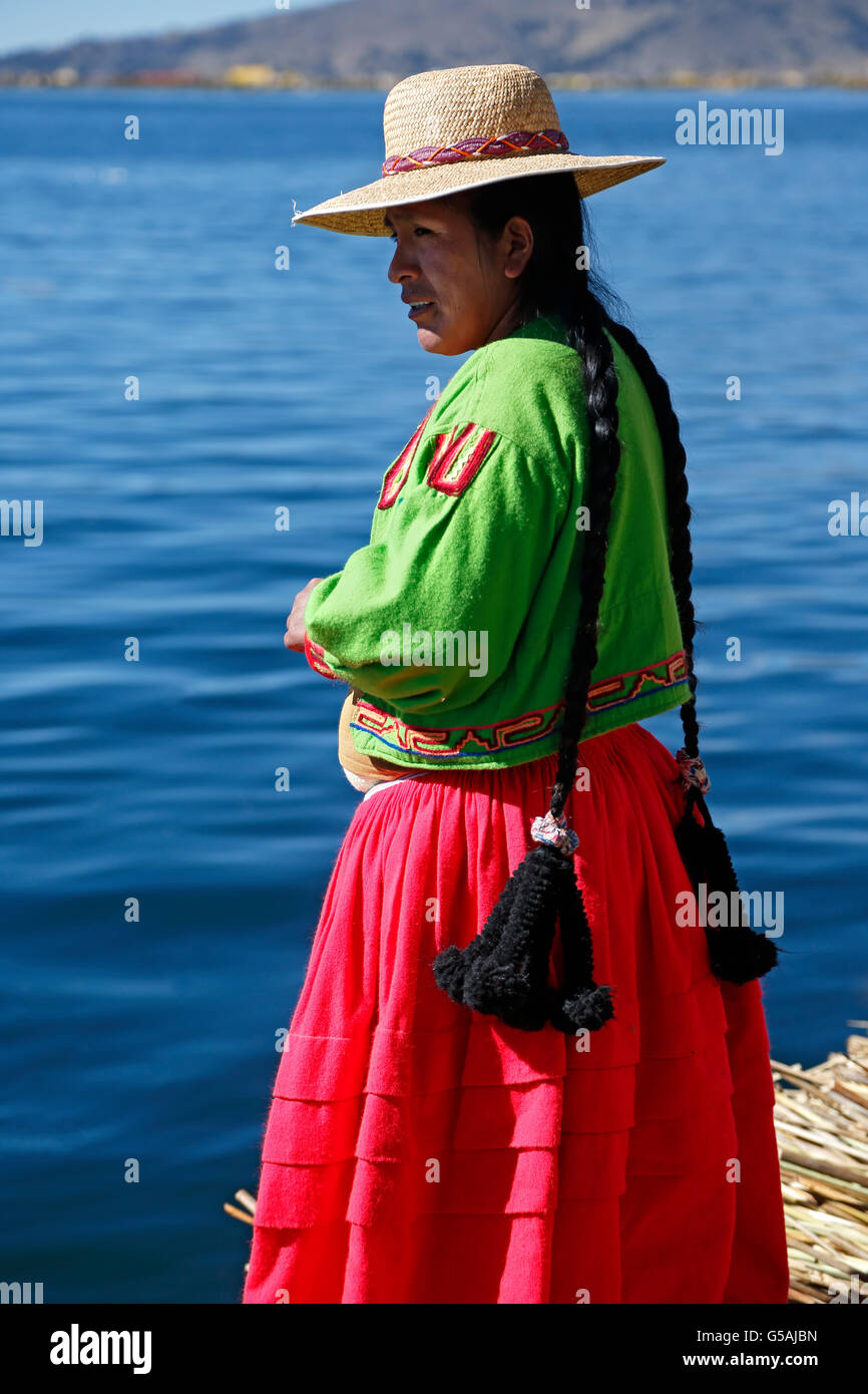 Uros woman on totora reed island, Uros Islands, Lake Titicaca, Puno, Peru Stock Photo
