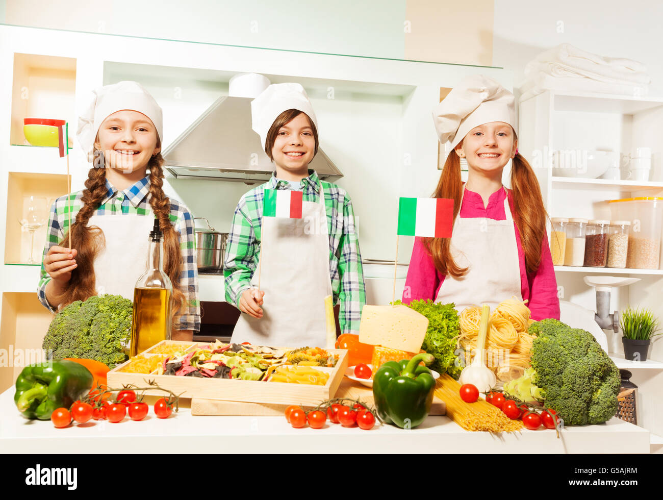 Young cooks preparing traditional Italian meal Stock Photo - Alamy