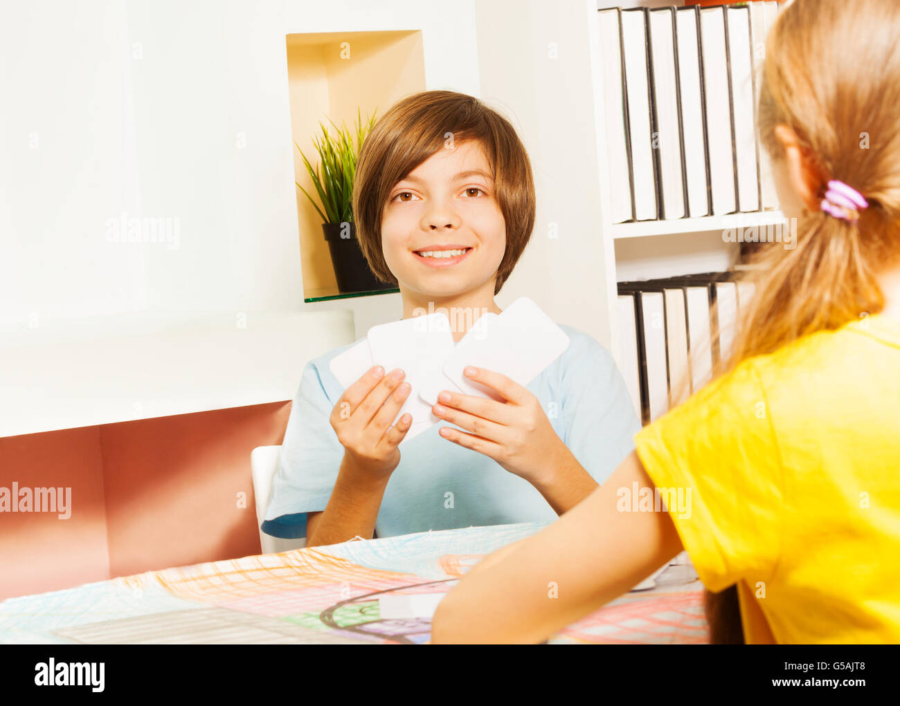 Smiling boy playing game with cards Stock Photo