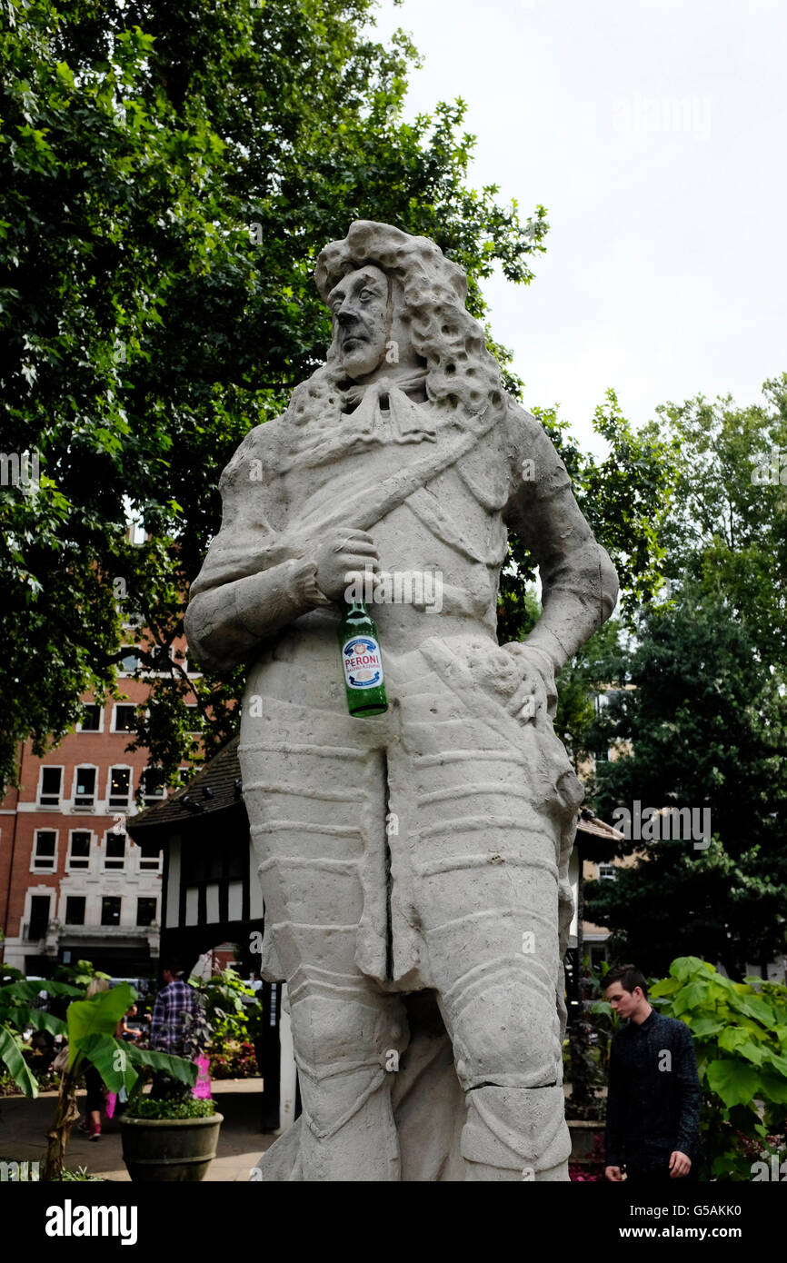 Statue holding beer bottle in Soho Square, London Stock Photo
