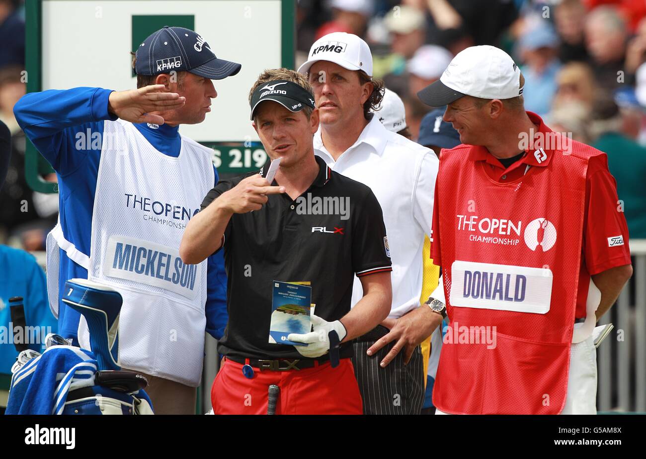 England's Luke Donald (2nd left) discusses his next tee shot with stand in caddy Gareth Lord during day two of the 2012 Open Championship at Royal Lytham & St. Annes Golf Club, Lytham & St Annes Stock Photo