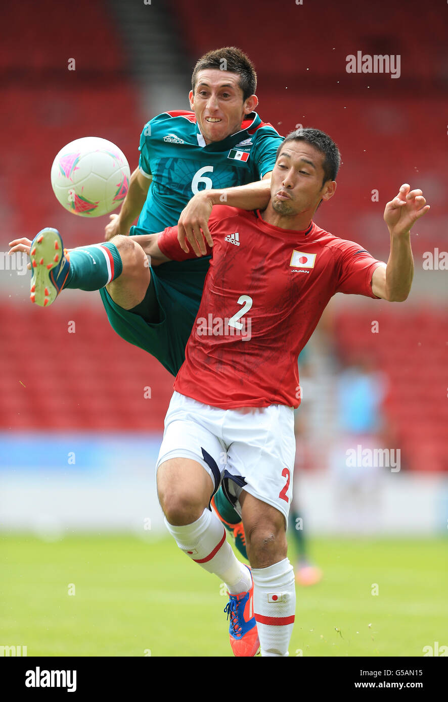Japan's Yuhei Tokunaga and Mexico's Hector Herrera battle for the ball Stock Photo