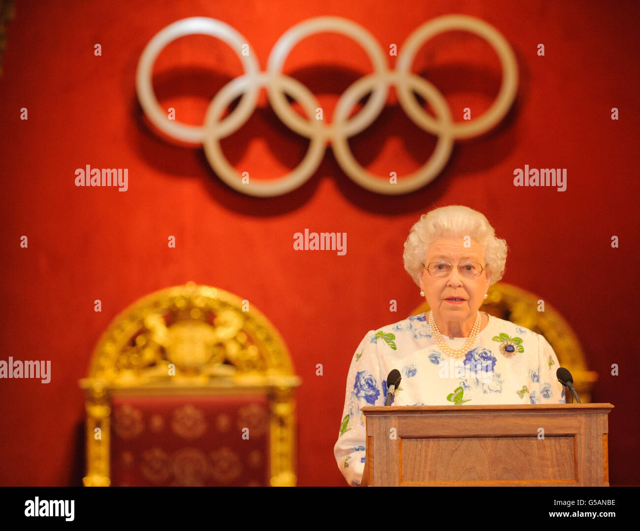 Queen Elizabeth II speaks at a reception for members of the International Olympic Committee, at Buckingham Palace, in central London. Stock Photo