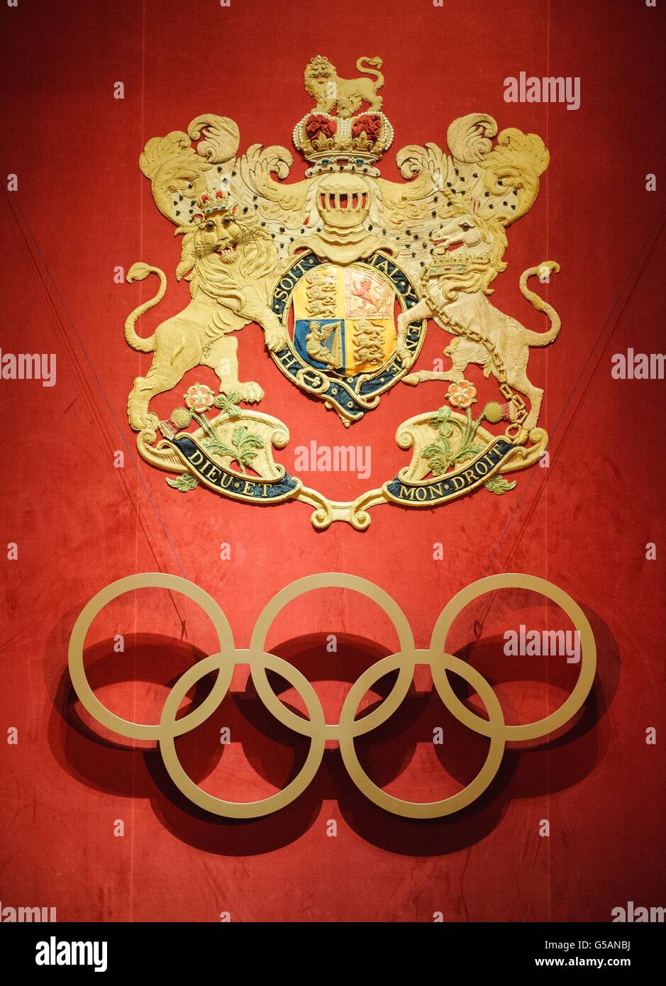 The coat of arms of the British royal family is seen alongside the Olympic rings at a reception for members of the International Olympic Committee, at Buckingham Palace, in central London. Stock Photo