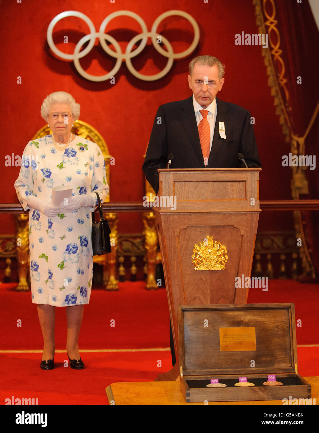 Queen Elizabeth II listens as President of the International Olympic Committee Count Jacques Rogge speaks at a reception for members of the International Olympic Committee, at Buckingham Palace, in central London. Stock Photo