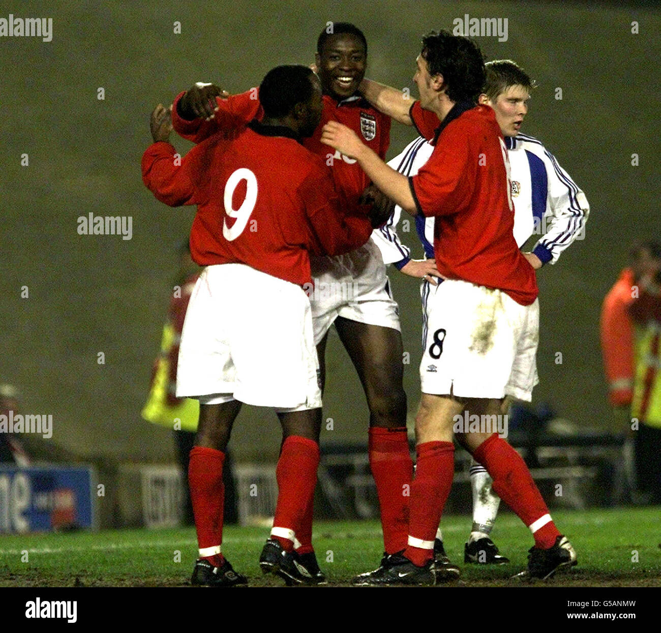 Shola Ameobi celebrates scoring his first and England's third goal with Darius Vassell and Jonathan Greening, during their Under 21st match at Barnsley. Stock Photo