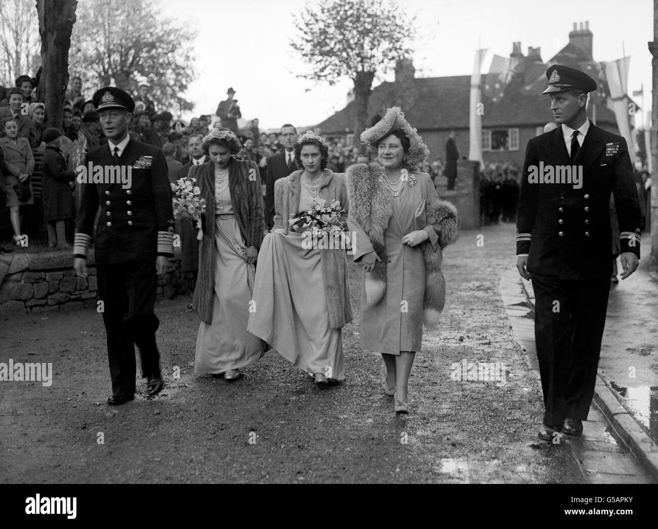 Three Royal Princesses were bridesmaids at the wedding of the Hon.Patricia Mountbatten to Captain the Lord Brabourne. Here, arriving at Romsey Abbey, are King George VI, Queen Elizabeth, Princess Elizabeth (2nd l), Princess Margaret and Lieutenant Philip Mountbatten (r). Stock Photo