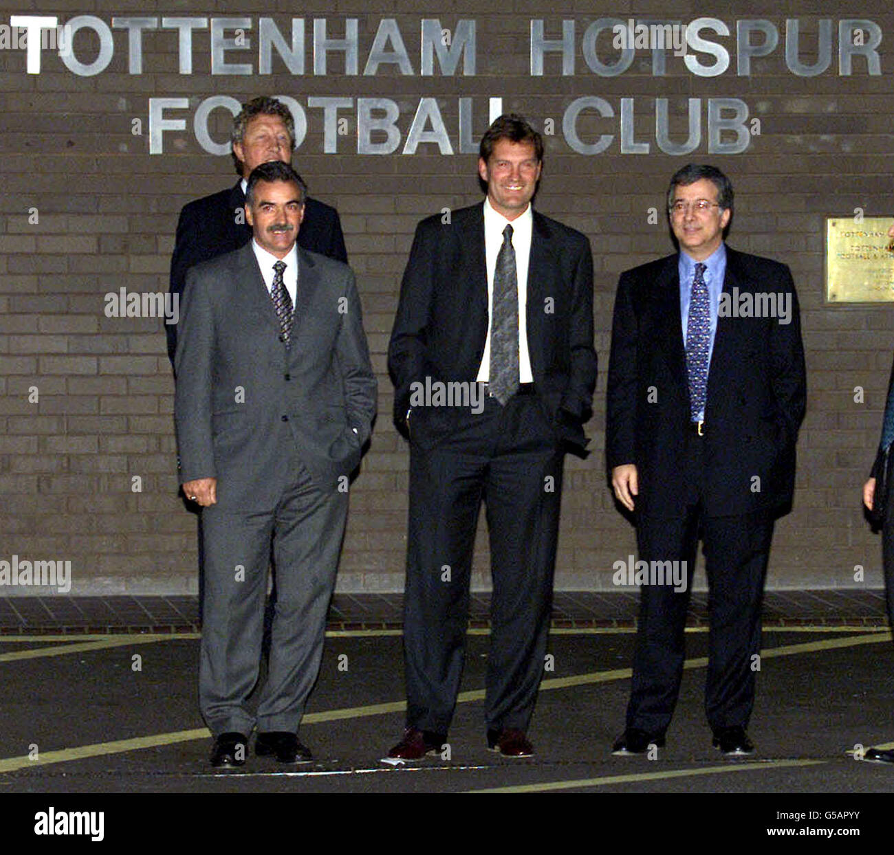 Newly appointed Tottenham Hotspur manager Glenn Hoddle (second from right) poses for photographers with his agent Dennis Roach (back, left), assistant John Gorman and Spurs executive vice-chairman David Buchler (right). Hoddle was unveiled as Tottenham s new manager at a White Hart Lane press conference. Stock Photo
