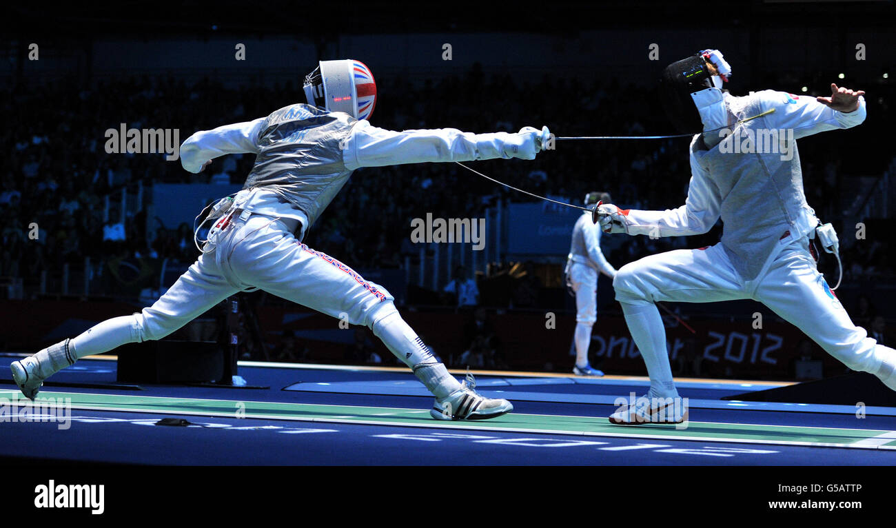 Great Britain's Richard Kruse (left) in action during his Fencing Men's Individual Foil, Round of 32 match against Russia's Artur Akhmatkhuzin at the ExCel Arena, London. Stock Photo