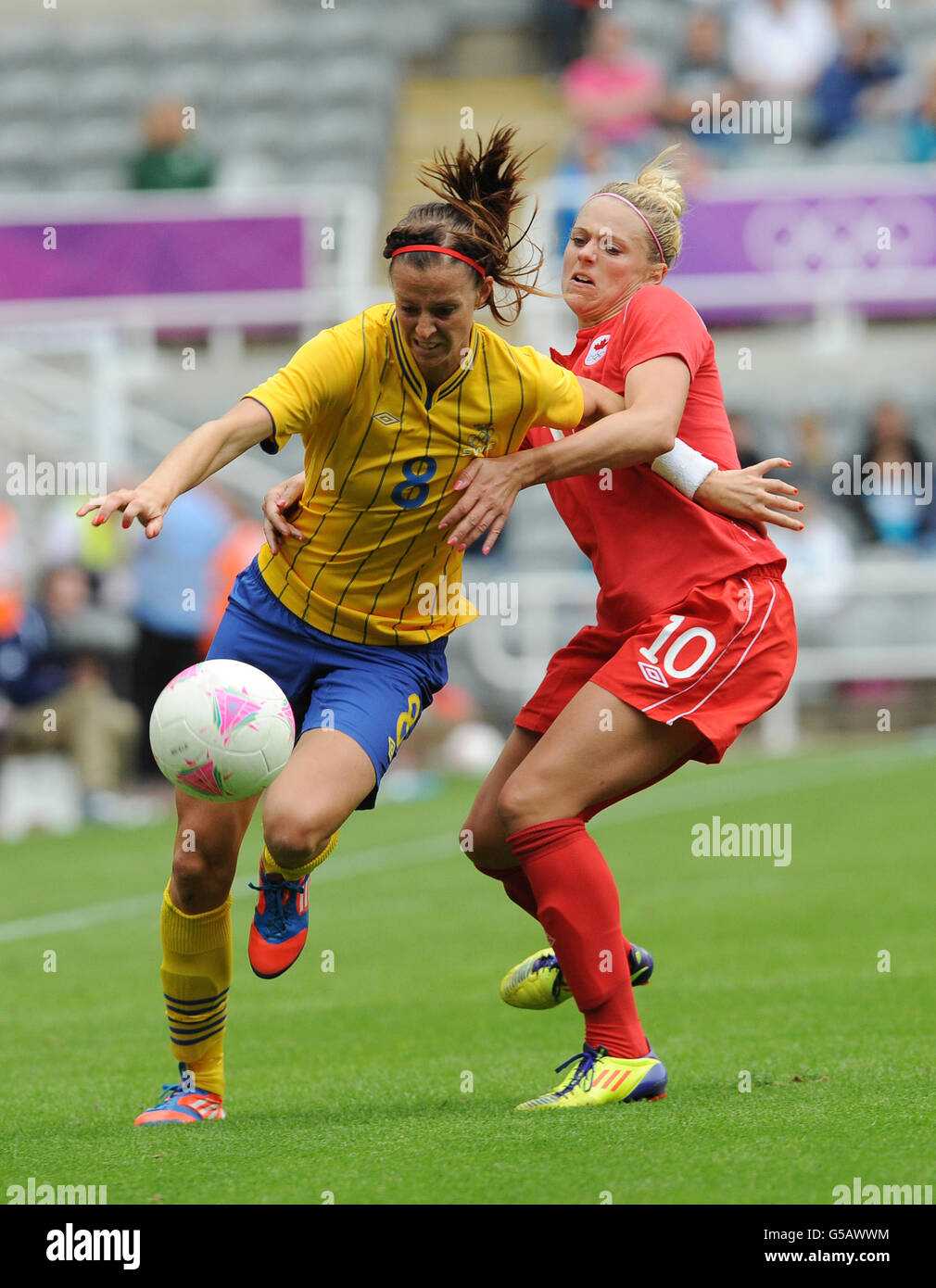 Sweden's Lotta Schelin (left) and Canada's Lauren Sesselmann battle for