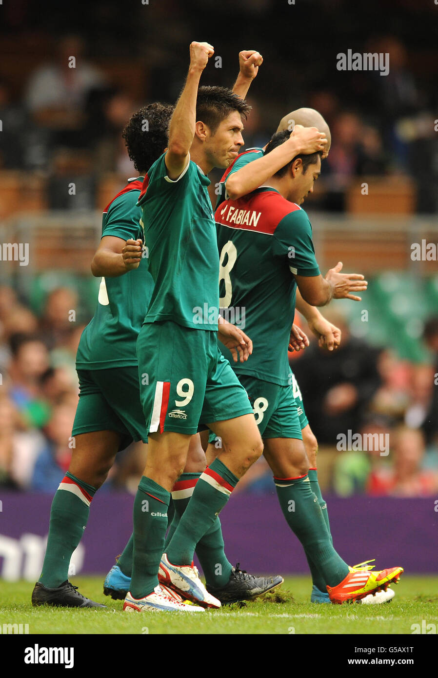 Mexico's Oribe Peralta celebrates scoring the opening goal of the game during the group B match against Switzerland at the Millennium Stadium Stock Photo