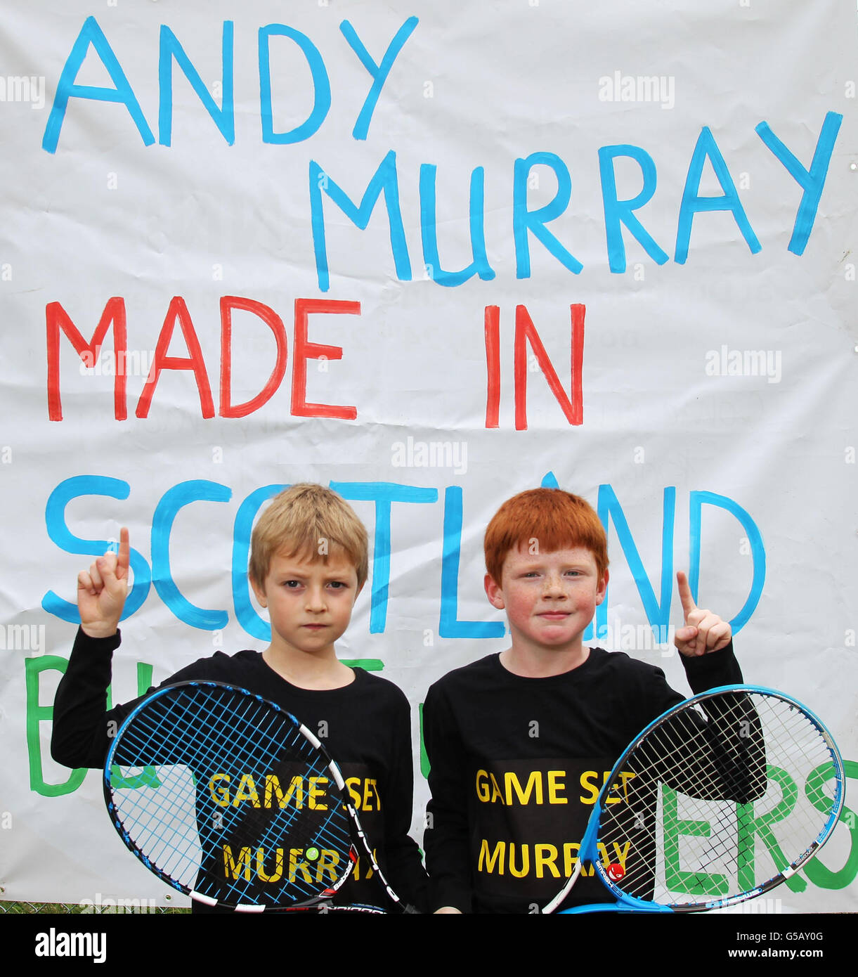 Dunblane Tennis Club members Finlay Sherriff 7 (left) and Sean Balman 8, both from Dunblane, strike the Andy Murray celebration pose, as the streets in Andy Murray's home town are almost deserted as tennis fans gather to watch his bid to become the first British man to win Wimbledon in 76 years. Stock Photo
