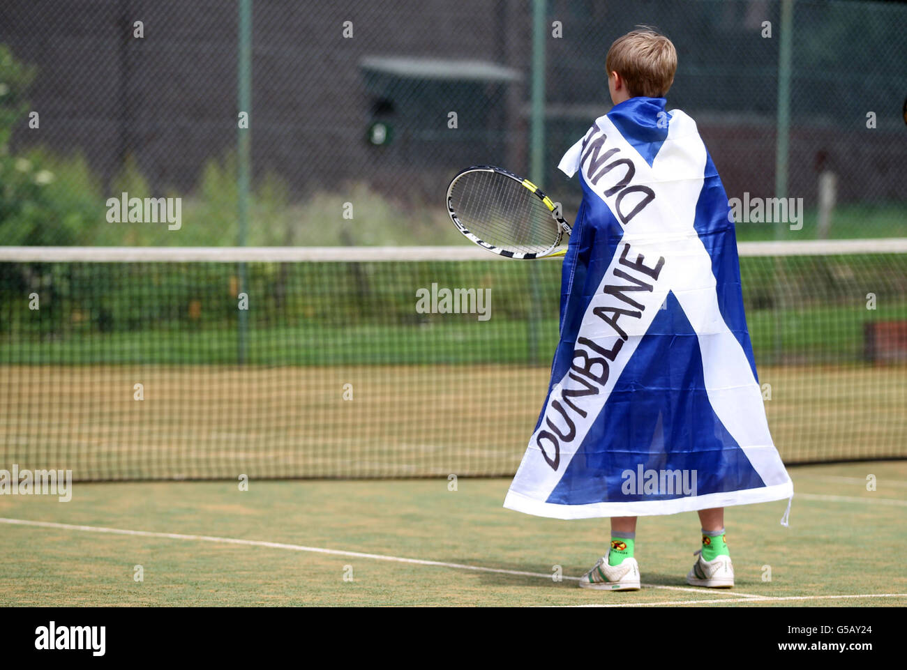 Dunblane Tennis Club member (name unknown) plays tennis during the match, as the streets in Andy Murray's hometown are almost deserted as tennis fans gather to watch his bid to become the first British man to win Wimbledon in 76 years. Stock Photo