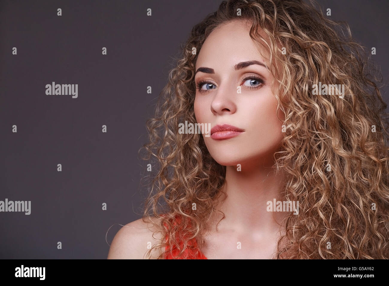Portrait of woman with curly hair Stock Photo - Alamy