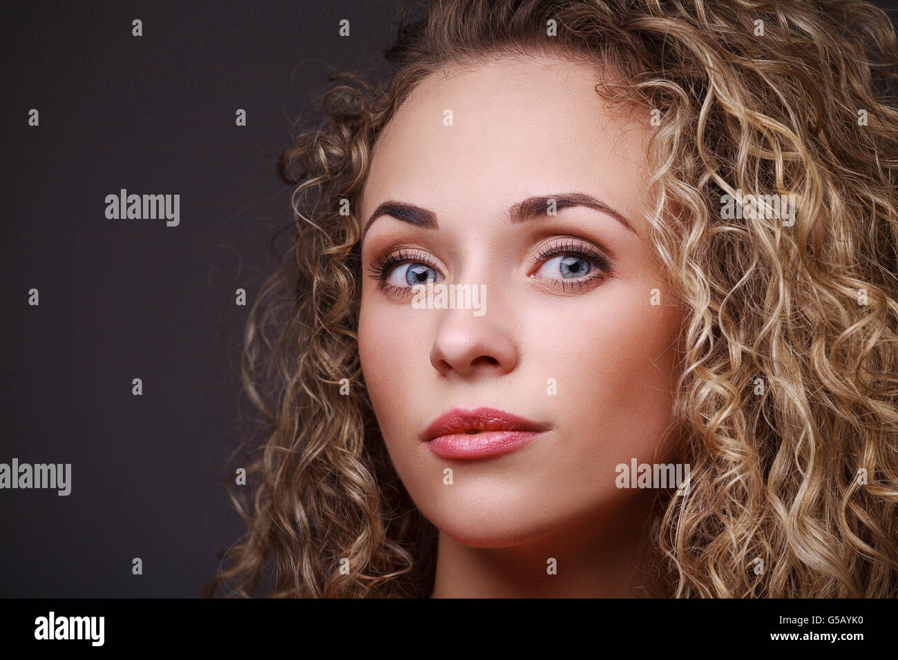 Portrait of woman with curly hair Stock Photo - Alamy