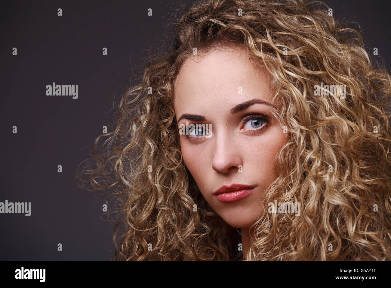 Portrait of woman with curly hair Stock Photo - Alamy