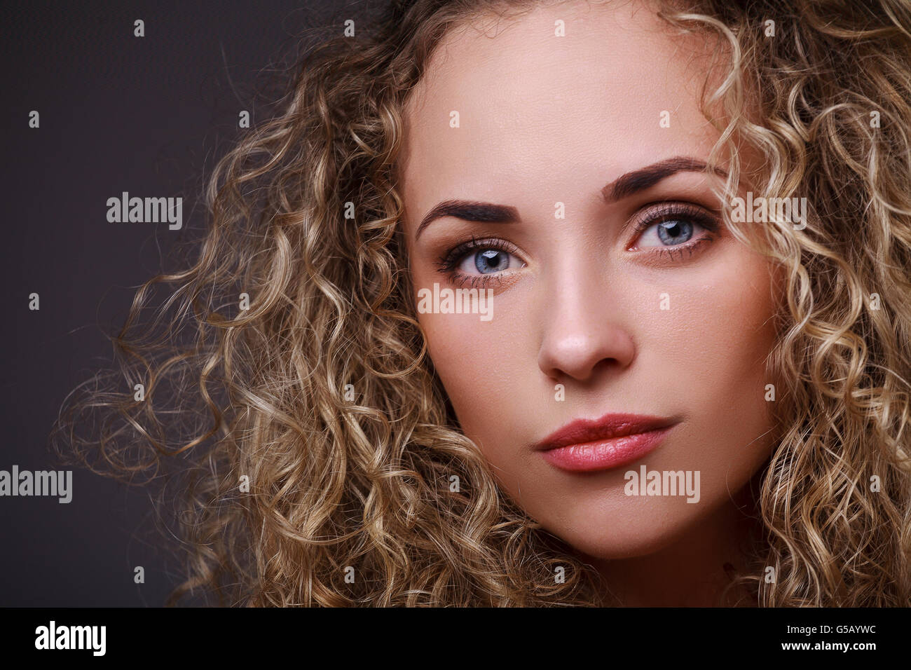 Portrait of woman with curly hair Stock Photo - Alamy