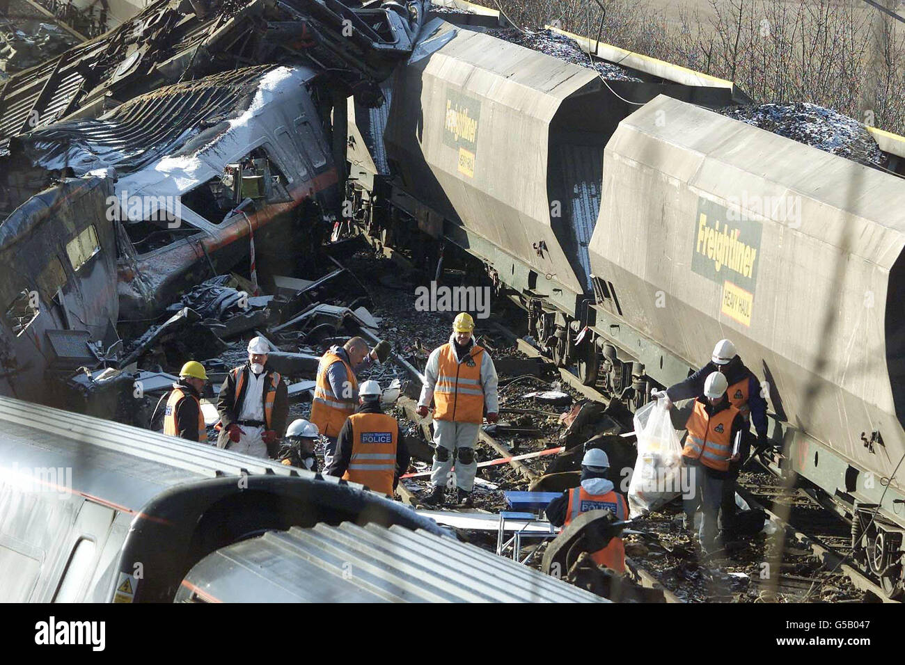 Emergency workers carry out a search and begin to remove personal belongings, at the scene at Great Heck, nr Selby, Yorkshire. Work is continuing following the railway crash in which 13 people are thought to have died. * However, police have warned that more bodies may be recovered as the process of lifting the wrecked carriage begins. Stock Photo
